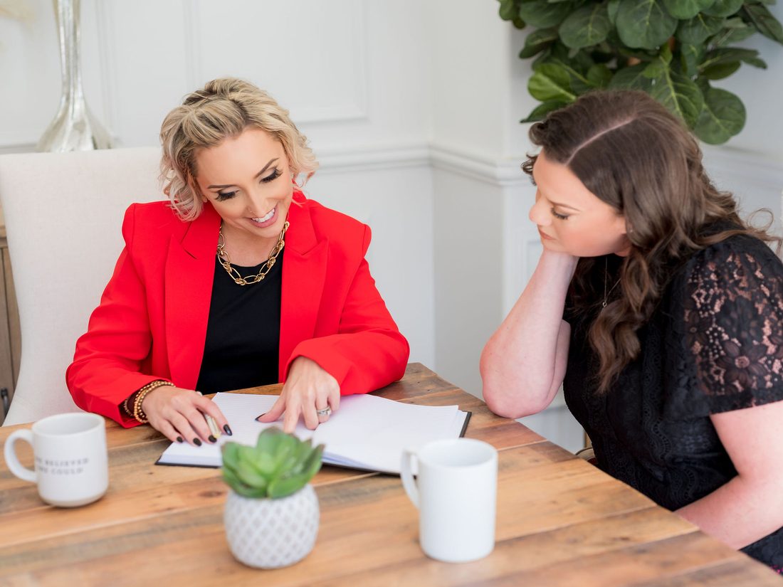 Glynis working through plans with a colleague at a table