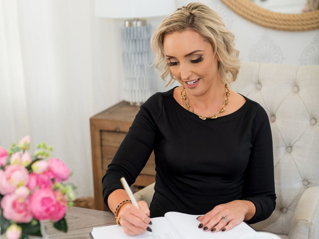 Glynis writing in a notebook